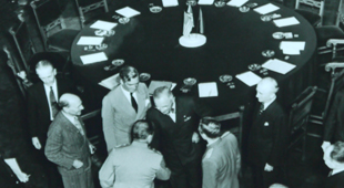 Conference participants standing by table